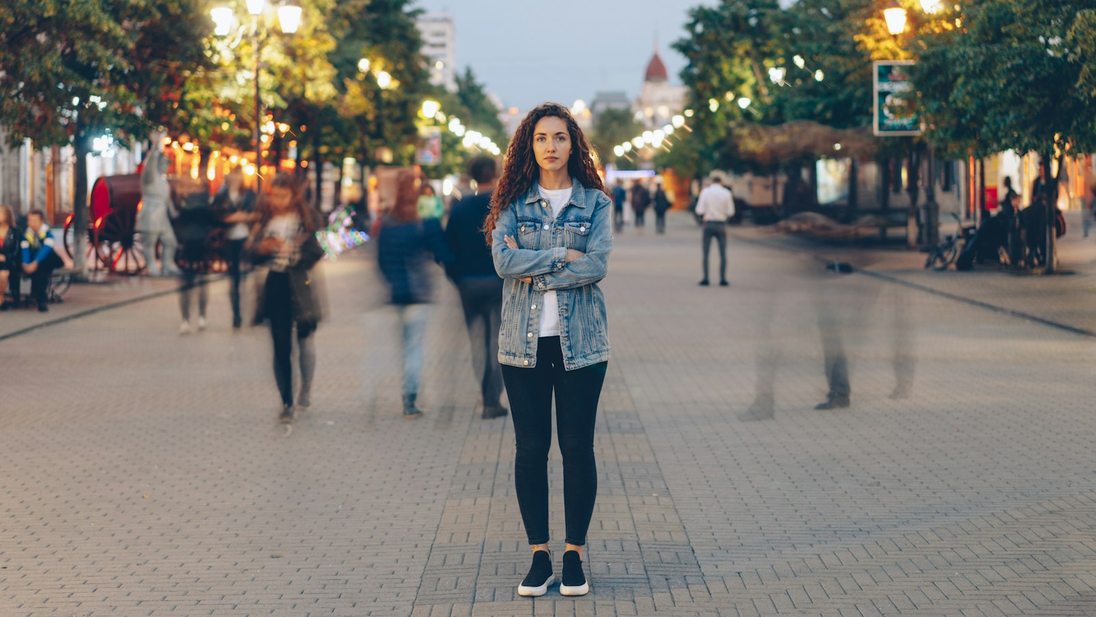 Woman standing still while the crowd rushes around her